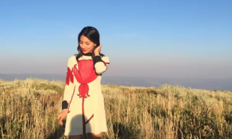 Young woman in a dress in a grass field